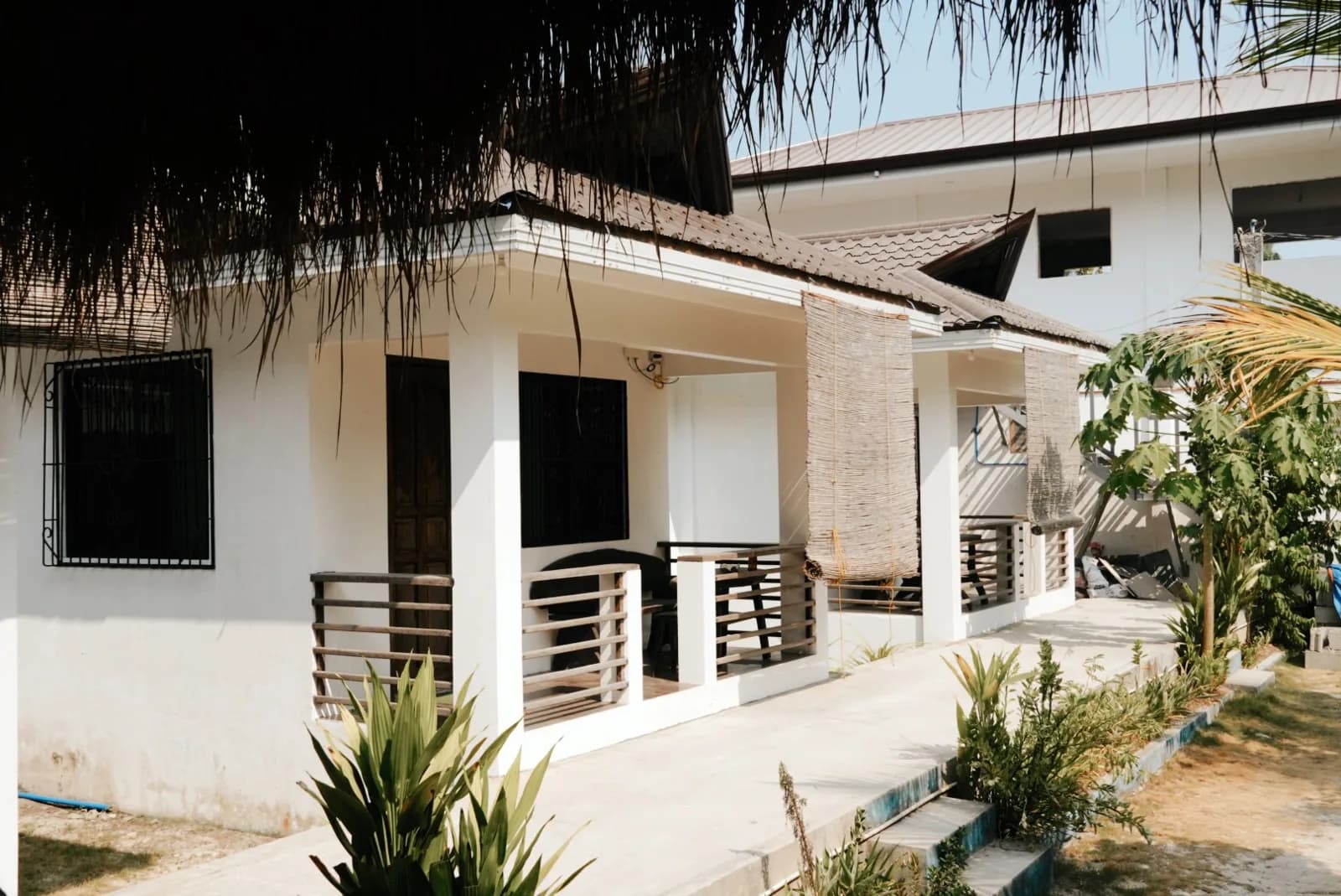 Exterior row of Double Rooms with Terrace beside the resort garden.