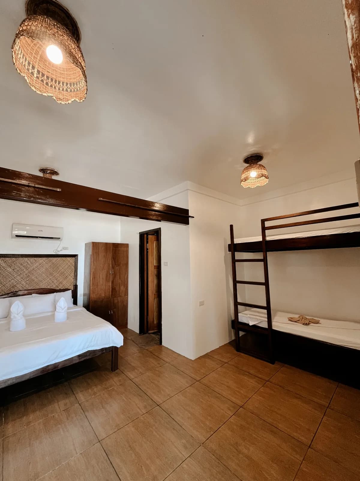 Beachfront Bungalow sleeping area with Queen bed and bunk beds for families or small groups.