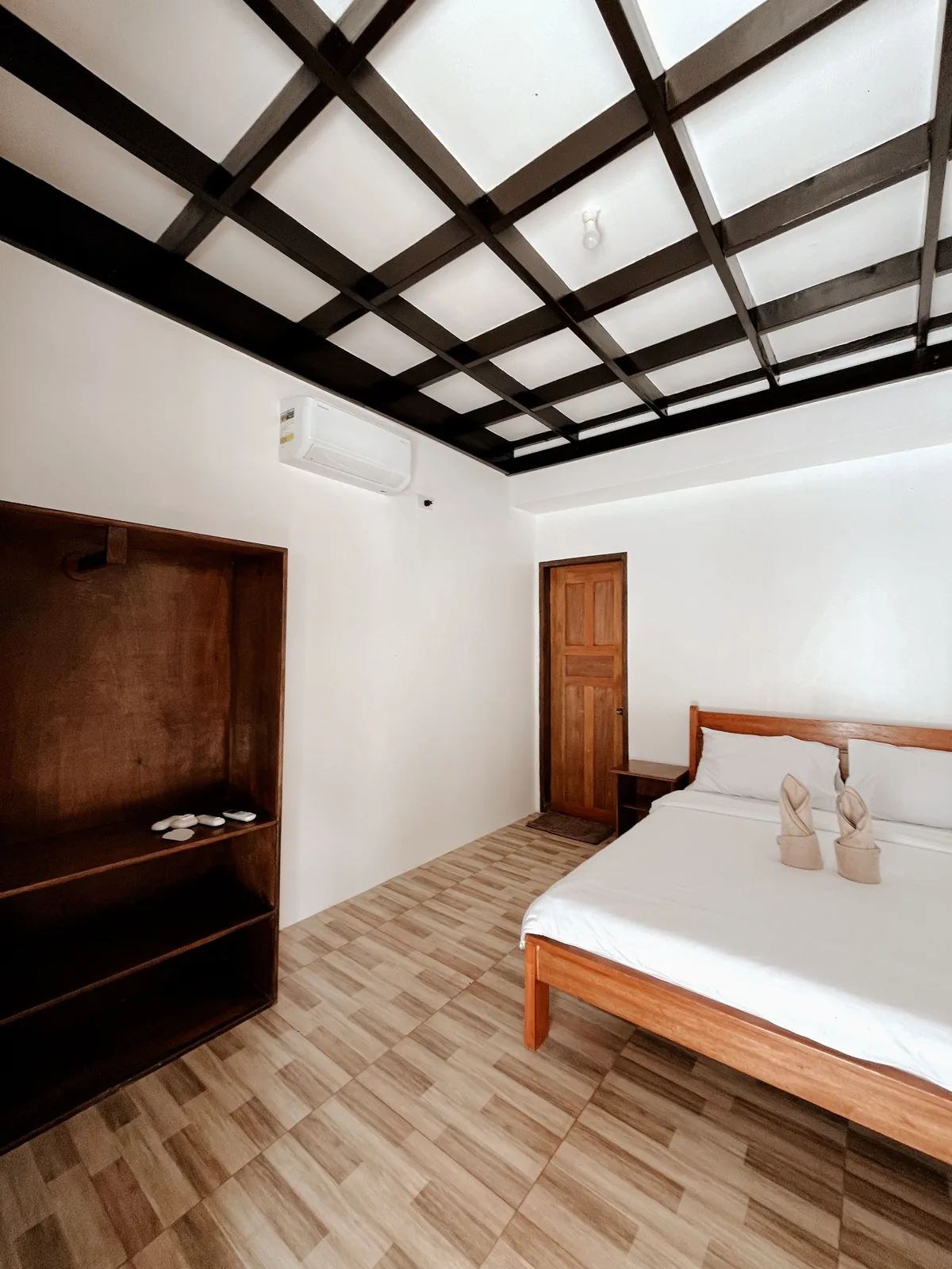 Wide view of the Double Room with Queen-size bed and air-conditioning.