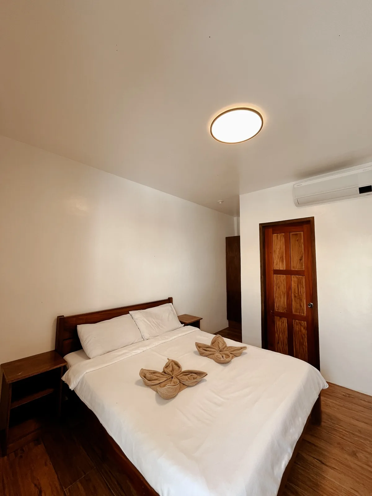 Alternative view of the Standard Room showing its Queen-size bed and room layout.